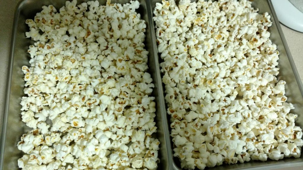 Spread popcorn onto 2 13x9" baking pans