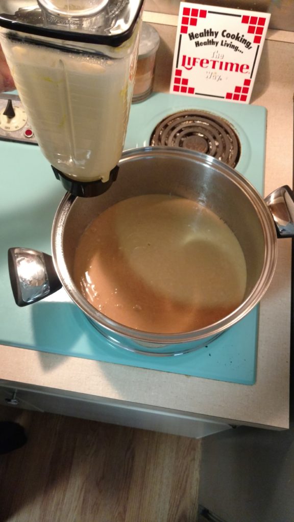 Pour blended flan into pan on top of cake mix