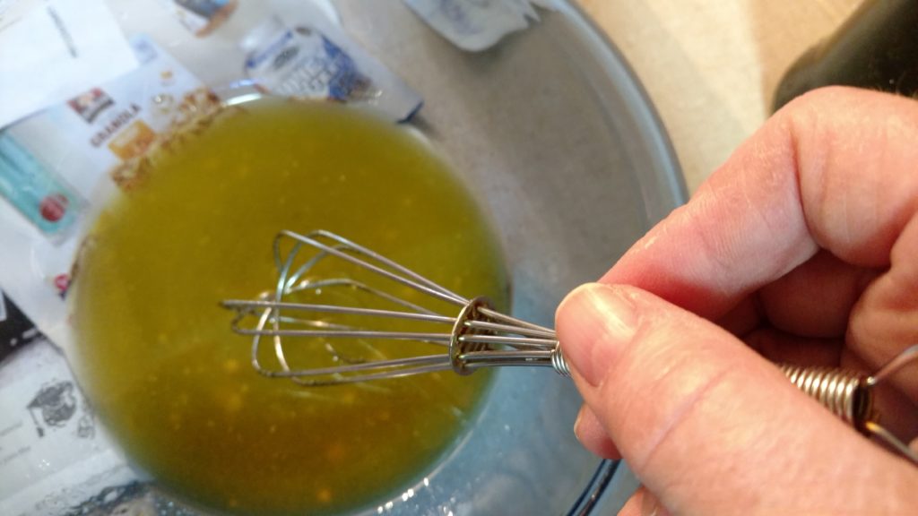 As you mix your vinaigrette, it will thicken slightly.  Pour into and incorporate it into the salad.